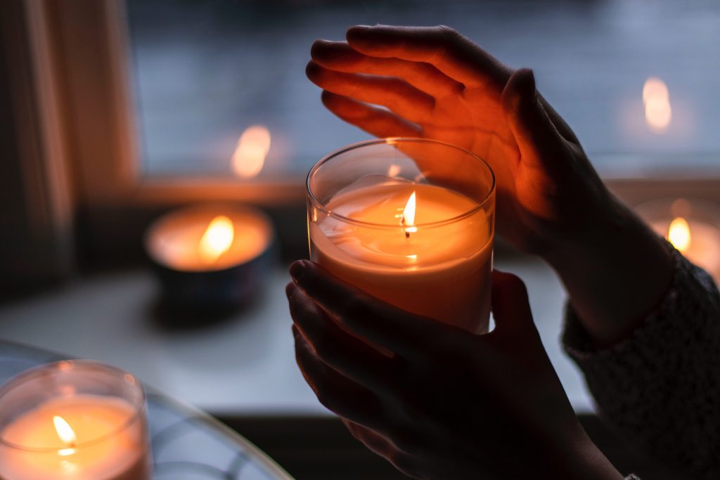 hand holding a candle